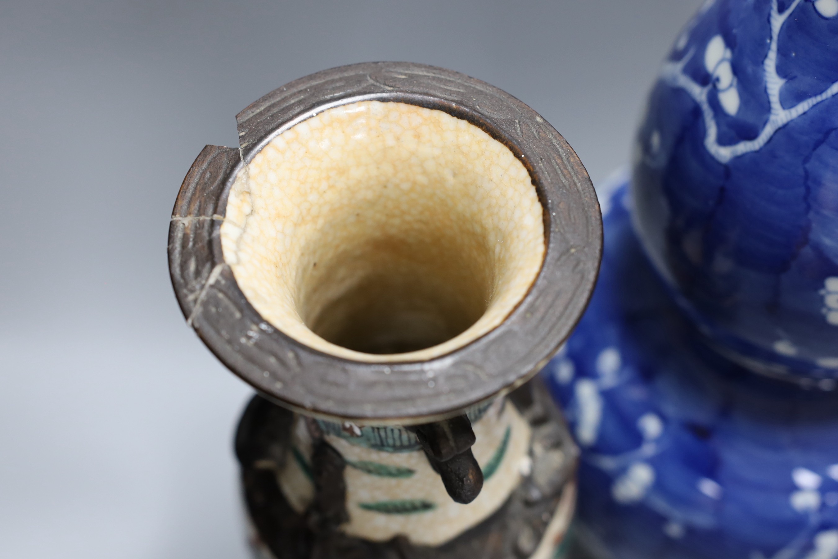A Chinese crackle glaze vase and jar and a blue with figural decoration, together with a Chinese blue and white prunus double gourd vase, tallest 37cm